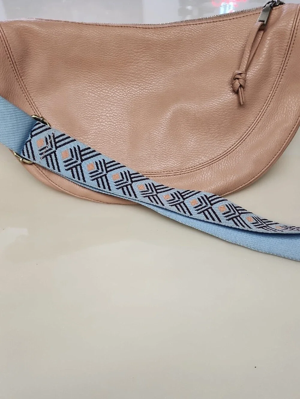 Urban Originals Peach Crescent Crossbody with Patterned Blue Strap
